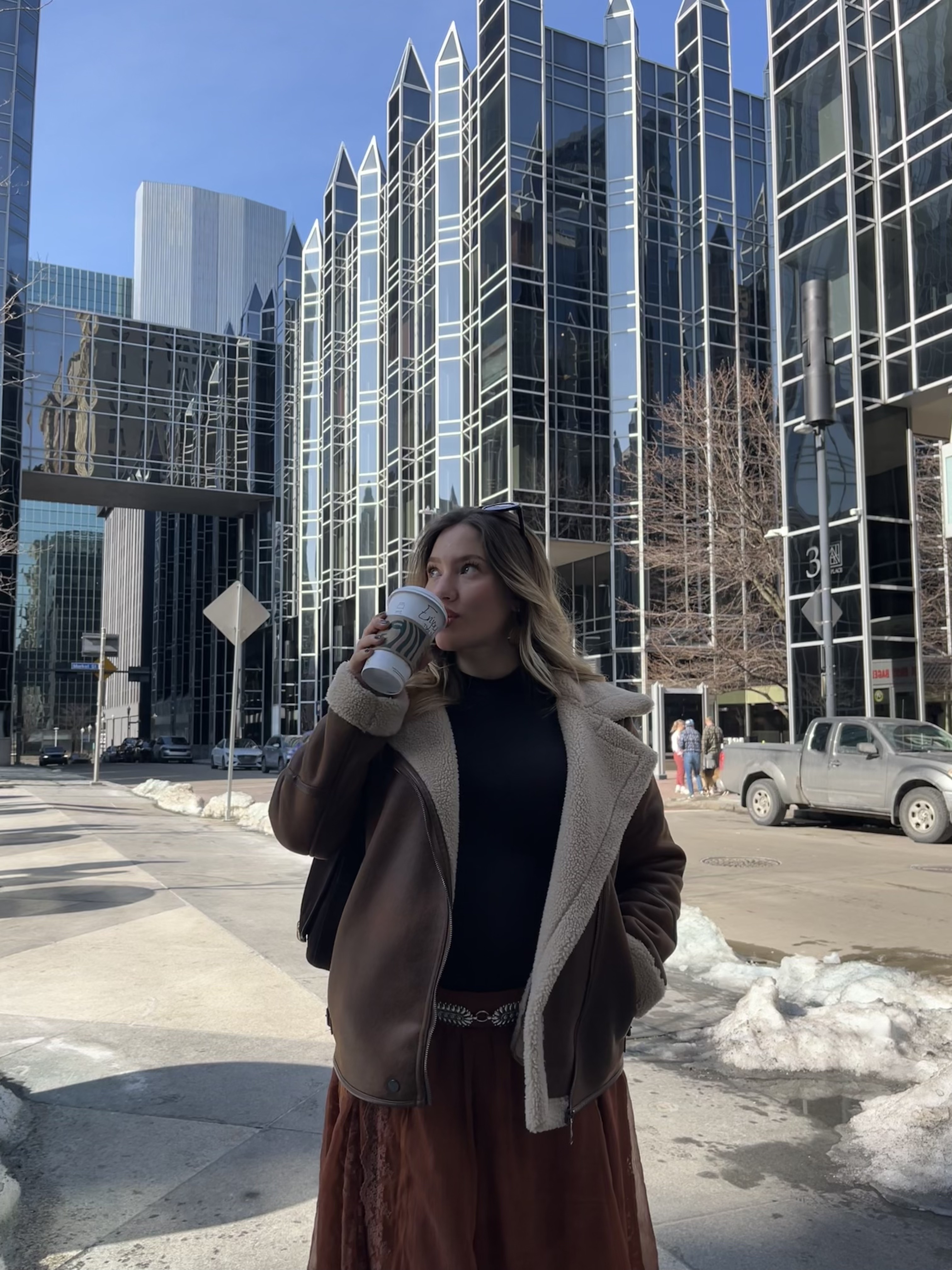 Joseth, founder of Aury Digital, holding a coffee in the city